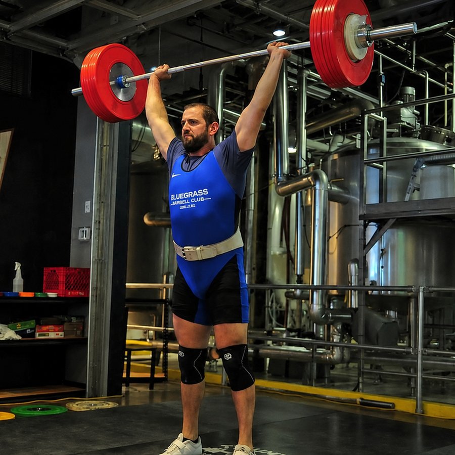 Ben Carter at the top of an Olympic snatch lift